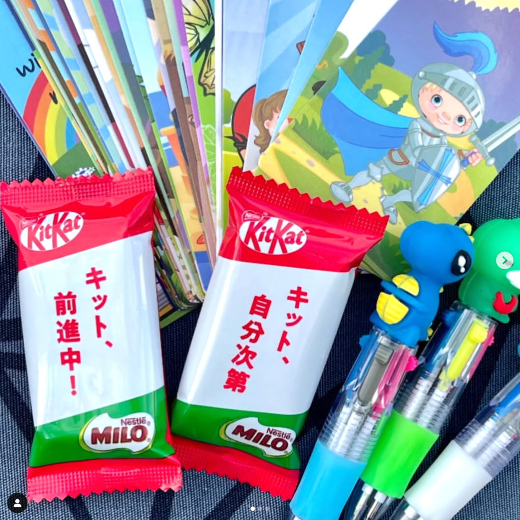 Photo of some items included in goody bags for the cover letters and resumes workshop: Japanese Milo-flavored Kit Kat chocolate snacks, colorful bookmarks, and character mascot pens.
