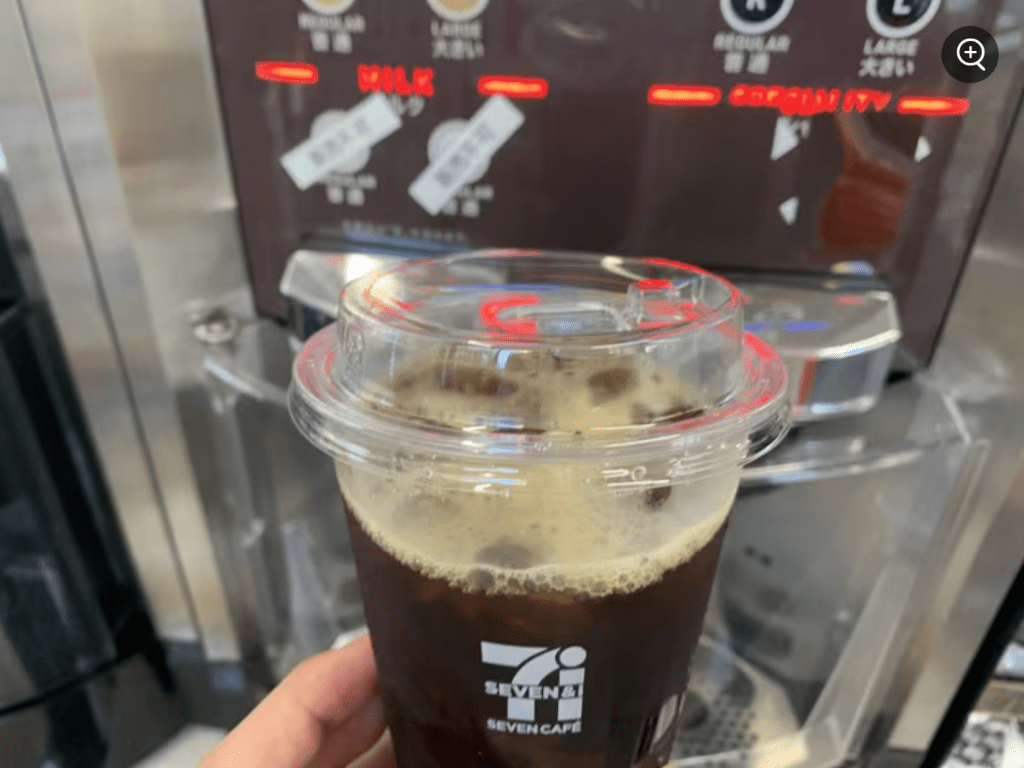 Image of a person getting ice coffee at the 7-11 convenience store using a self-service coffee machine.
